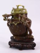 A CHINESE CARVED JADE VASE & COVER, carved with foliage, fitted upon a carved wooden base, 17cm