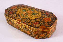 A 19TH CENTURY PERSIAN LACQUER LIDDED BOX, with floral decoration, 14cm x 7cm.