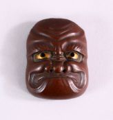 A JAPANESE MEIJI PERIOD BRONZE NOH MASK, with gilt eye decoration, 5.5cm high x 4cm