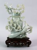A CHINESE CARVED JADE FLORAL URN & COVER, carved with a display of flora and birds, upon a carved