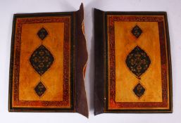 A GOOD 19TH CENTURY PERSIAN LACQUER BOOK COVERS, painted with bands of calligraphy and floral