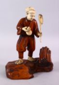 A JAPANESE MEIJI PERIOD CARVED IVORY AND WOOD OKIMONO OF A WOOD CUTTER, stood holding his axe