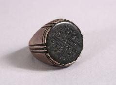 A 19TH CENTURY ISLAMIC CARVED JADE INTAGLIO STYLE & SILVER RING, with carved inset jade with