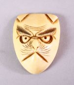 A JAPANESE MEIJI PERIOD CARVED IVORY NETSUKE MASK OF A FOX - KITSUNE, himotoshi formed to the