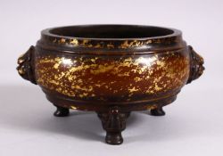 A CHINESE BRONZE & SPRAY GILT DECORATED INCENSE BURNER, with twin moulded lion head mask handles, on