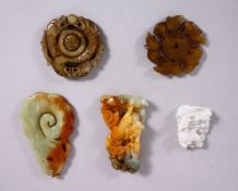 A COLLECTION OF FIVE CHINESE CARVED JADE PENDANTS, one of a dragon on currency, one of rats, one