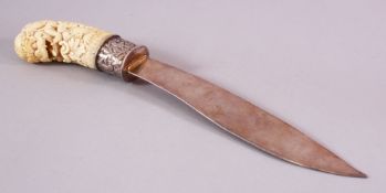 A 19TH CENTURY CARVED INDIAN IVORY MYTHICAL BEAST PAGE TURNER, carved with a mythical beast