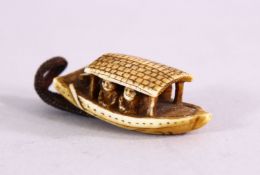A JAPANESE MEIJI PERIOD CARVED IVORY NETSUKE OF A BOAT - with two carved figures inside, artist
