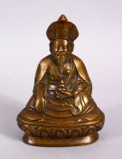 A CHINESE BRONZE FIGURE OF BUDDHA,L in a seated position holding an implement, 13cm.