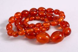 A SET OF CHINESE QING AMBER PRAYER BEADS, with 44 graduating carved beads, approx. 70cm open