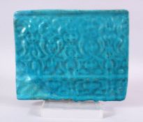 AN ISLAMIC TURQUOISE TILE SECTION, with moulded motif design, 20cm x 24cm.