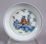 A CHINESE DOUCAI PORCELAIN PLATE - depicting two figures in a landscape with bats, six character