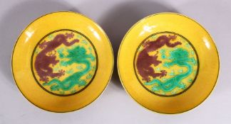 A PAIR OF CHINESE YELLOW GROUND INCISED DRAGON SAUCERS, with green and brown dragons upon yellow
