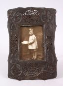 AN ISLAMIC PERISAN OPENWORK METAL CALLIGRAPHIC PHOTO FRAME, with a panel of pierced openwork with
