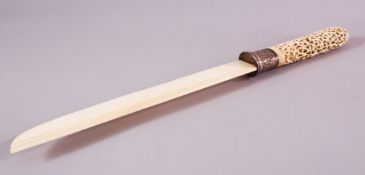 A 19TH CENTURY INDIAN CARVED IVORY OPENWORK PAGE TURNER, the handle carved with an openwork cage