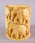 A JAPANESE MEIJI PERIOD CARVED IVORY ELEPHANT TUSK VASE / POT, carved with a heard of elephants in