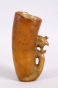 A CHINESE 20TH CENTURY CARVED SOAPSTONE LIBATION CUP, with a phoenix head carved handle, 15cm high.
