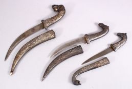 A LOT OF THREE 19TH CENTURY SILVER INLAID NIELLO DAGGERS, One with an elephant head handle, with a