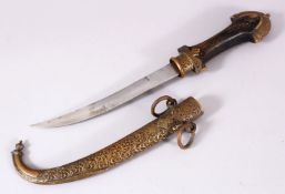 A GOOD ISLAMIC MOROCCAN DAGGER, with a carved brass sheath, and carved wood handle, 41cm