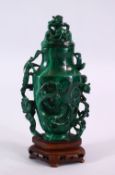 A CHINESE CARVED MALACHITE LIDDED VASE AND COVER, carved with kylin & stylized clouds and ruyi, with