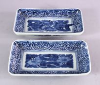 A PAIR OF JAPANESE MEIJI PERIOD BLUE & WHITE RECTANGULAR PORCELAIN DISHES - each decorated with