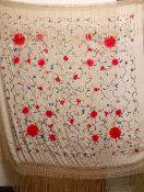 A CHINESE EMBROIDERED SILK PIANO SHAWL - finely embroidered to depict scrolling display of flora,
