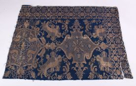 A RARE ISLAMIC EMBROIDERED TEXTILE FRAGMENT, on blue ground with gold colour embroidery.