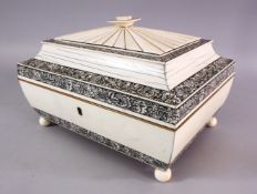 A 19TH CENTURY INDIAN CARVED IVORY LIDDED SEWING BOX, with bands of black stained and inlaid ivory