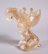 A CHINESE CARVED GLASS LIBATION CUP OF EROTIC FORM, a female figure with her hands tied behind her