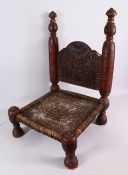 AN AFRICAN CARVED WOODEN CHAIR - with a woven seat and carved back, 72cm h x 48cm wide x 46cm