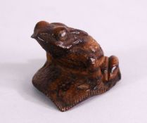 A JAPANESE 19TH / 20TH CENTURY CARVED WOOD SEATED FROG UPON LEAF - the frog in a seated position