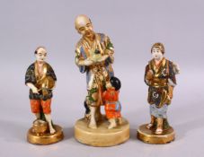 THREE JAPANESE SATSUMA CERAMIC FIGURES, depicting a man and boy with catch, underside signed, 18cm