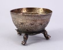 A SMALL THAI EMBOSSED SILVER BEZOAR STONE BOWL, on three feet, 6cm wide.