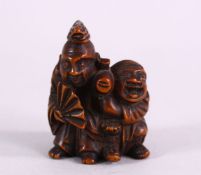 A JAPANESE MEIJI PERIOD CARVED BOXWOOD NETSUKE OF TWO MEN - KARAKO - the pair appearing to be actors