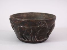 AN EARLY SUMERIAN POTTERY RAM BOWL, with relief carved rams, 13cm