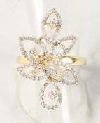 AN UNUSUAL YELLOW GOLD AND DIAMOND DRESS RING of flower form.