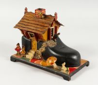 A CARVED AND PAINTED WOOD MUSICAL JEWELLERY BOX. 8.5ins long.