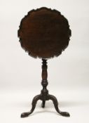 A GEORGE III DESIGN MAHOGANY TILT TOP TRIPOD TABLE, with piecrust circular top, turned column