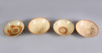 A LOT OF FOUR EARLY CHINESE POTTERY BOWLS, some glazed some unglazed. largest 16cm diameter.