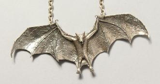 A HEAVY SILVER BAT DESIGNER NECKLACE.