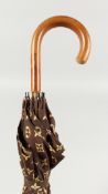 A LOUIS VUITTON UMBRELLA with wooden handle. 3ft long.