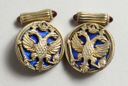 A GOOD PAIR OF RUSSIAN SILVER AND BLUE ENAMEL CROWN AND EAGLE CUFFLINKS.