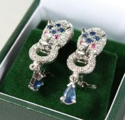 A PAIR OF SILVER AND SAPPHIRE SET PANTHER EARRINGS in the Cartier style.