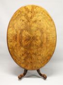 A GOOD VICTORIAN FIGURED WALNUT OVAL LOO TABLE, with quartered top, centre column support, ending in
