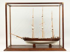 A MODEL OF A THREE MASTED SAILING SHIP, housed in a display case. Ship 27ins long.