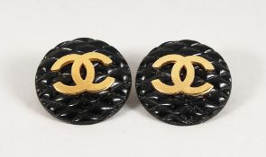 A PAIR OF CHANEL DOUBLE C GILT AND BLACK EARRINGS, in a Chanel box.