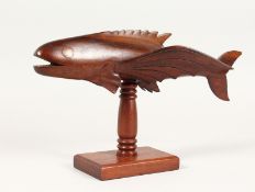 A PITCAIRN ISLAND CARVED WOOD FLYING FISH ON STAND, signed WILES WARREN. 12ins long.