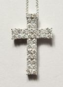A SUPERB 18CT WHITE GOLD DIAMOND CRUCIFIX, 1.30ct on a chain.