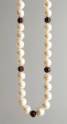 A STRING OF PEARLS WITH DIAMOND AND ENAMEL BEADS.