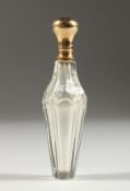 A GLASS GOLD TOP SCENT BOTTLE AND STOPPER. 11cms long.